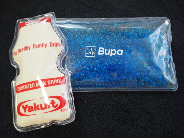 A Yakult bottle-shaped ice pack and a blue Bupa gel pack, perfect as unique corporate gifts.