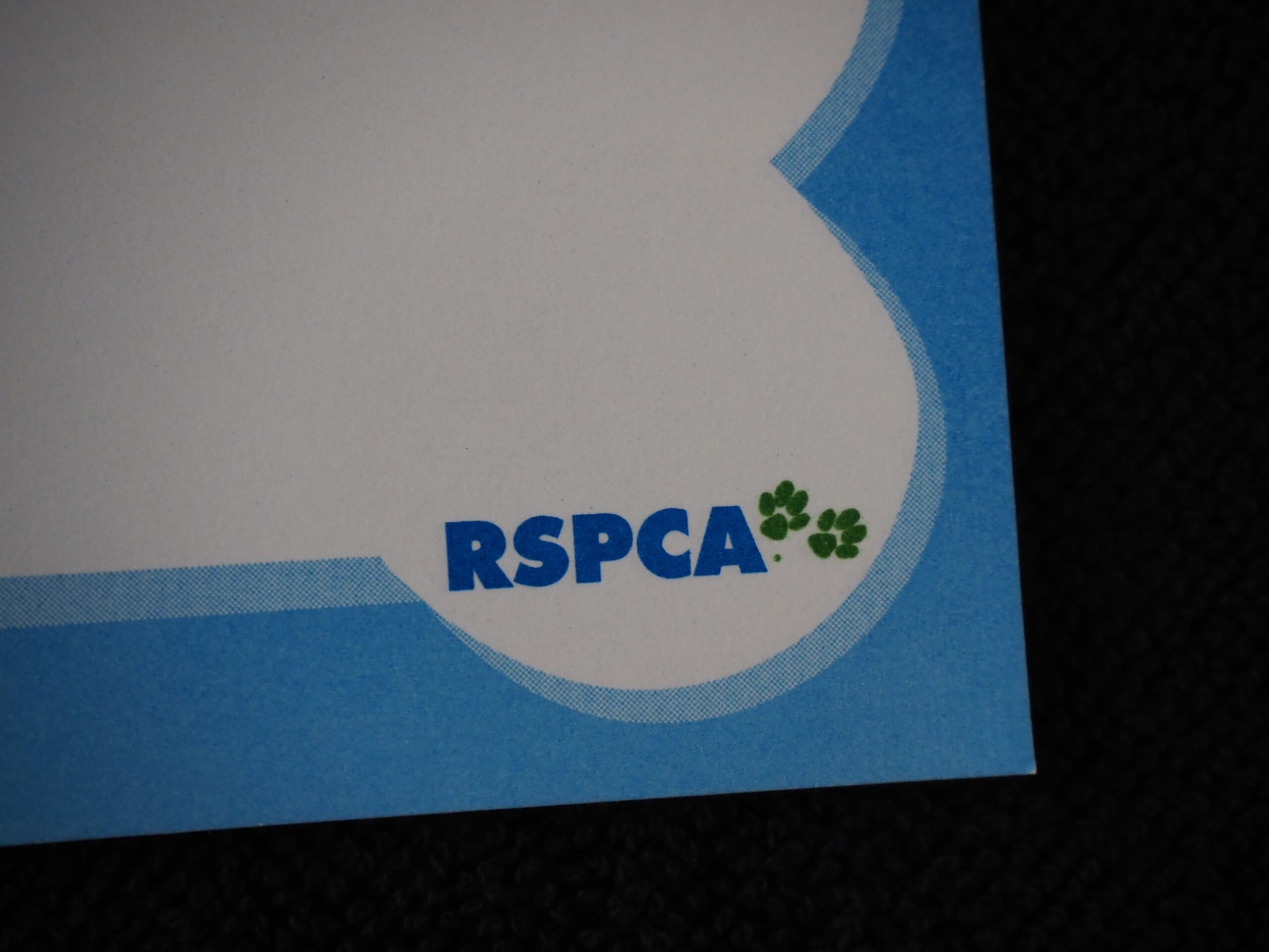 RSPCA Australia logo with green paw prints on a blue and white animal welfare background.