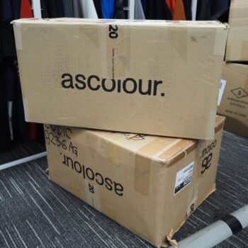 Two ASColour boxes stacked on the floor, ready for placing an order in the storage area.