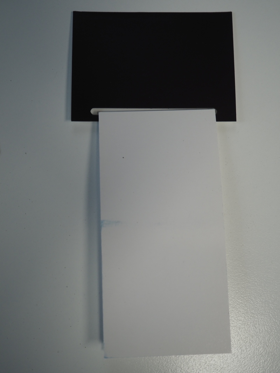 A black card on a white sheet symbolizing tender loving care for disability support.