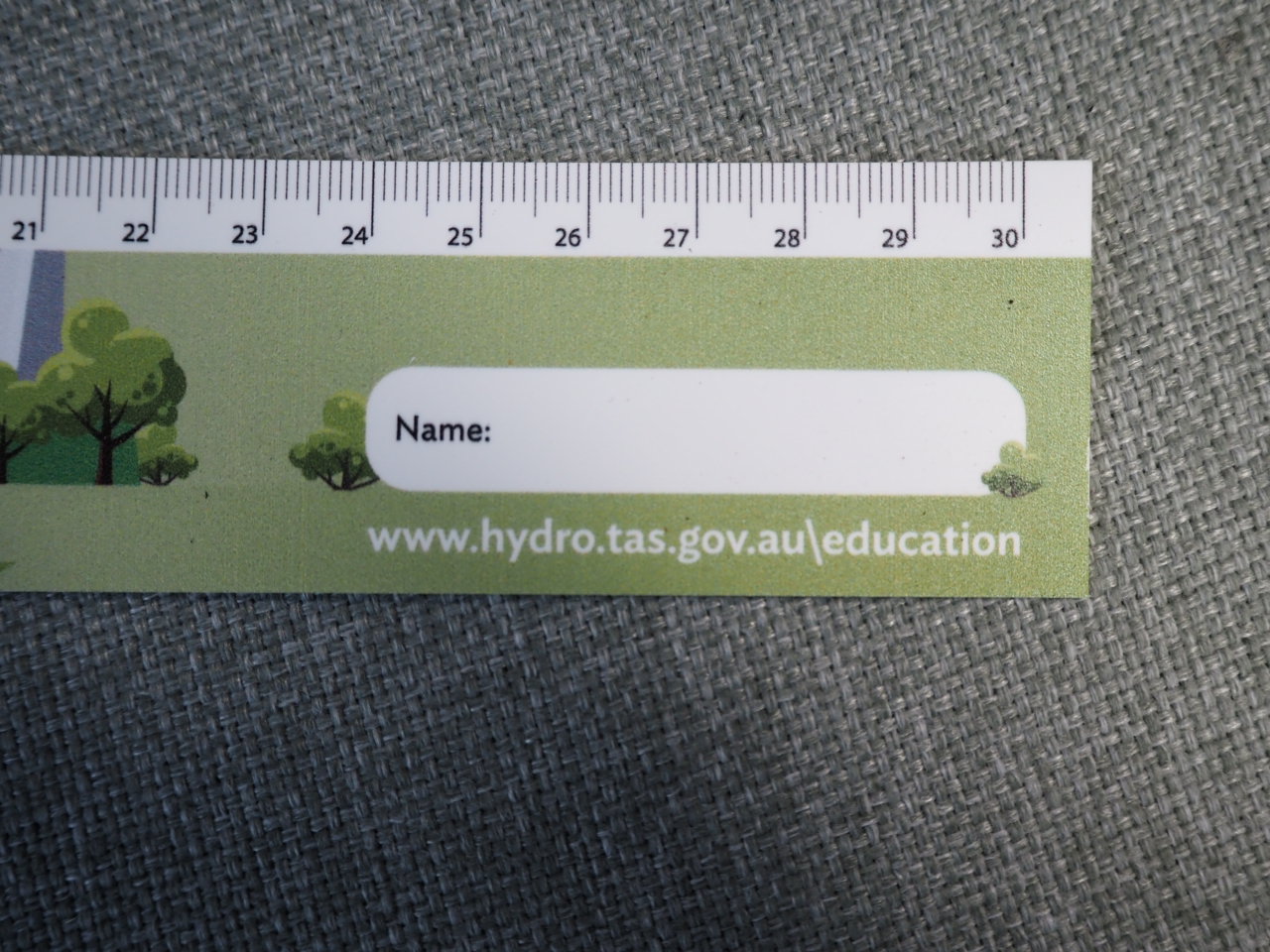 Green ruler with a name label, Hydro Tasmania and hydro.tas.gov.au/education printed on it.