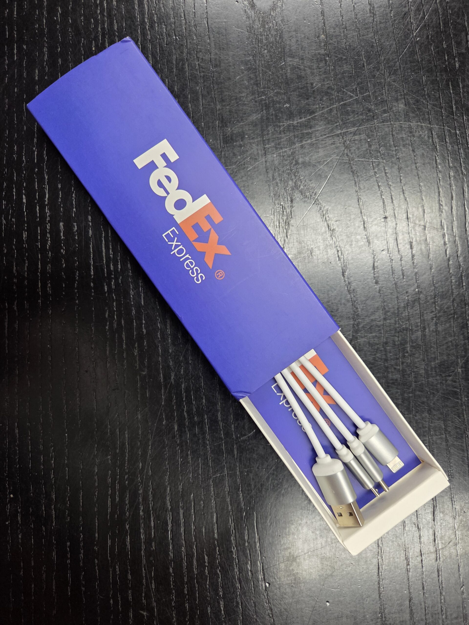 A FedEx Express box with charging cables, showing why promotional products work.