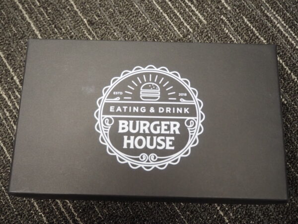 Black box with BURGER HOUSE logo—perfect for unique corporate gift box ideas.