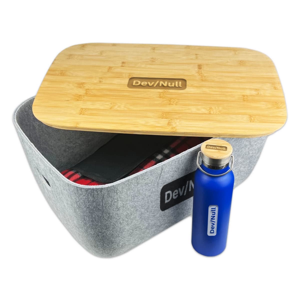 Gray felt storage bin with wooden lid, blue bottle, and an Ava Tub - rush blanket inside.