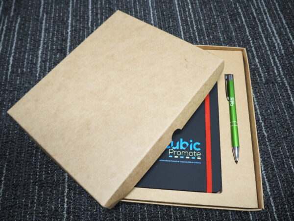 A notebook and green pen in a brown box—elegant picks for corporate gift box ideas.