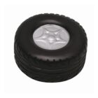 Round black Stress Ball Tyre - rush with a silver hubcap center, viewed from above.
