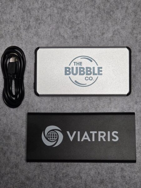 Two branded power banks and a USB cable—practical promotional products on gray felt.