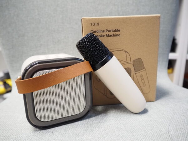 A portable karaoke machine with mic, perfect for unique corporate gift box ideas.