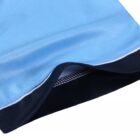 Close-up of Year 12 School Leaver Polos in light blue and black on a white background.