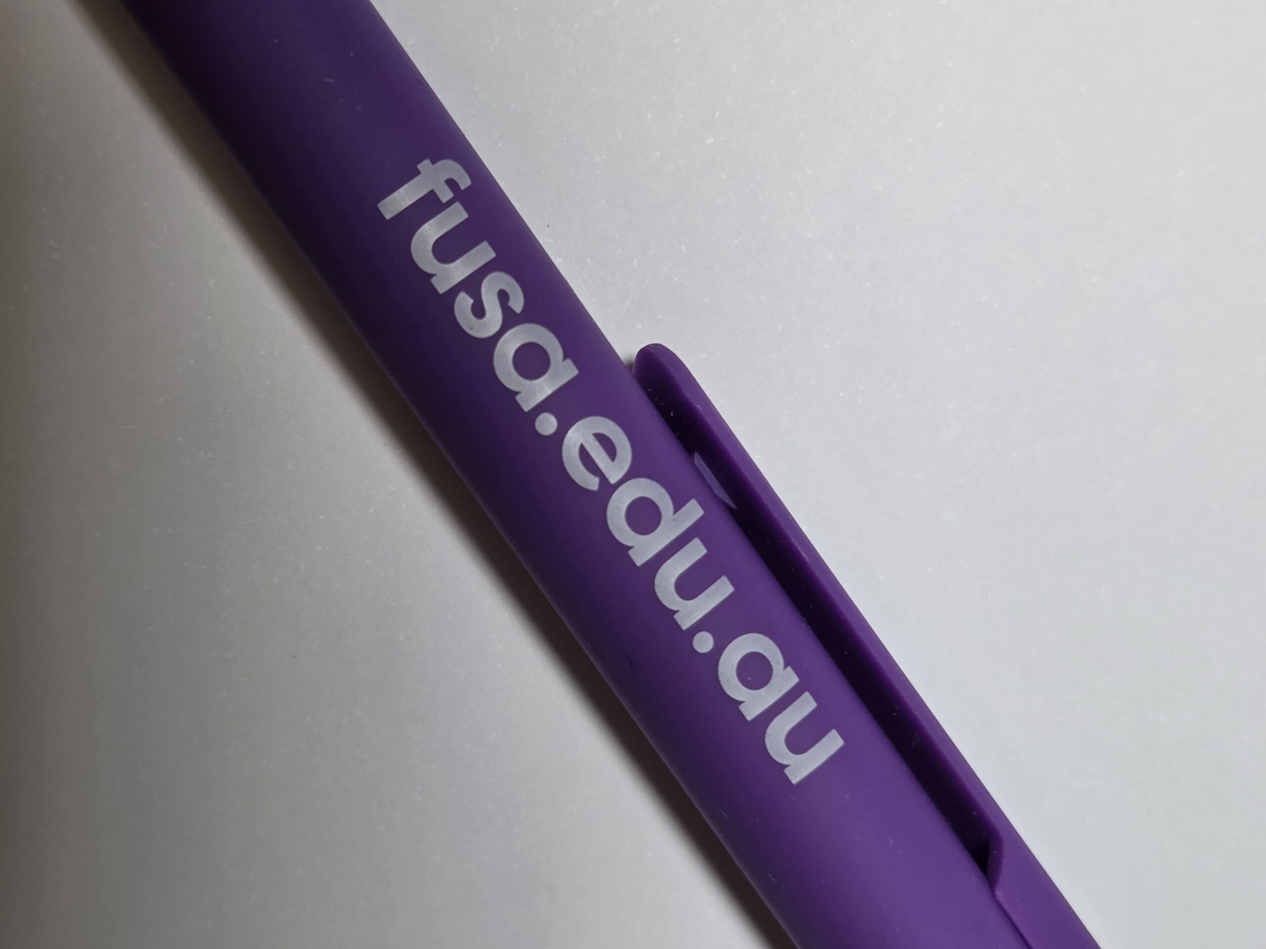 A purple pen with Flinders University Student Association and fusa.edu.au in white letters.
