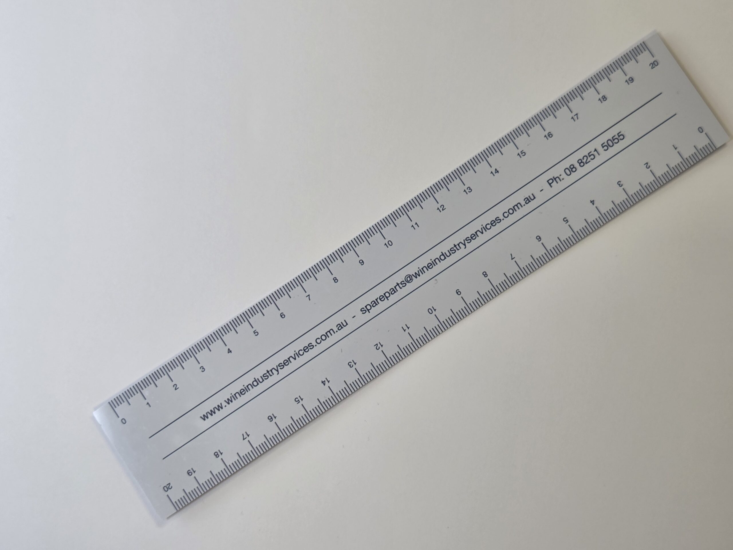 A clear plastic ruler with black markings, perfect for Wine Industry Services branding.