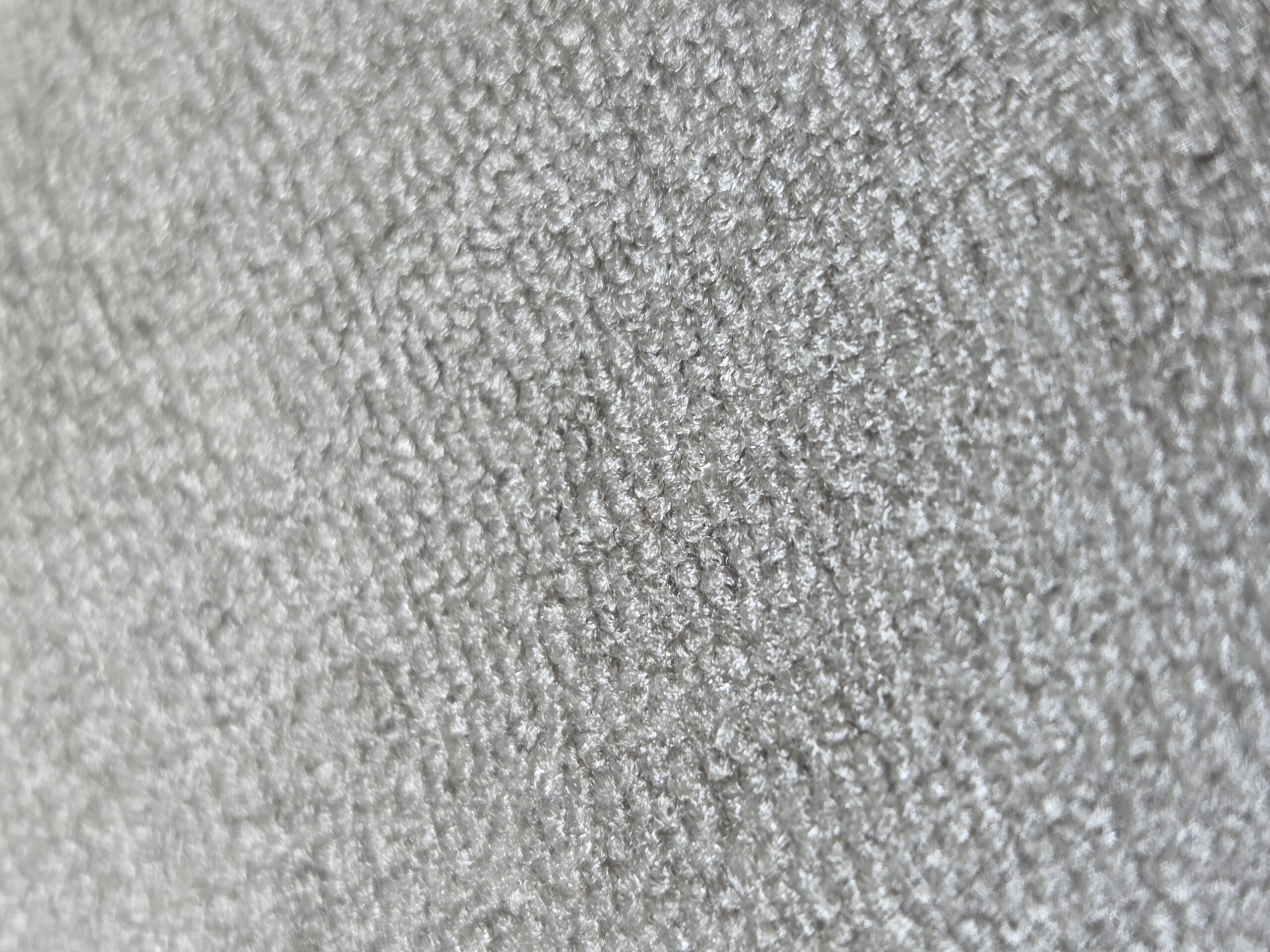 Close-up of a soft, light gray fabric surface, featured in a recent Rockwell Client story.