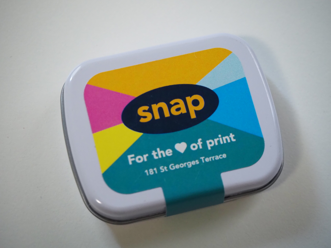 A colorful Snap tin, perfect for a Happy Client—For the ♥ of print, 181 St Georges Terrace.