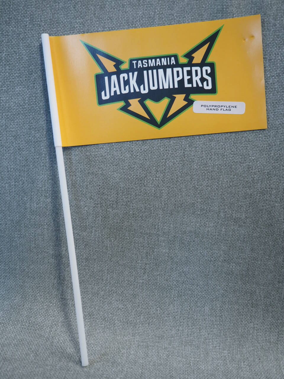 Yellow Tasmania JackJumpers mini flag on a white stick, perfect for any client story backdrop.