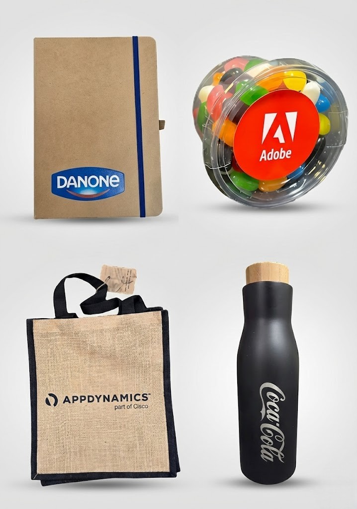 Four branded promotional products Brisbane: notebook, candy jar, tote bag, and bottle.