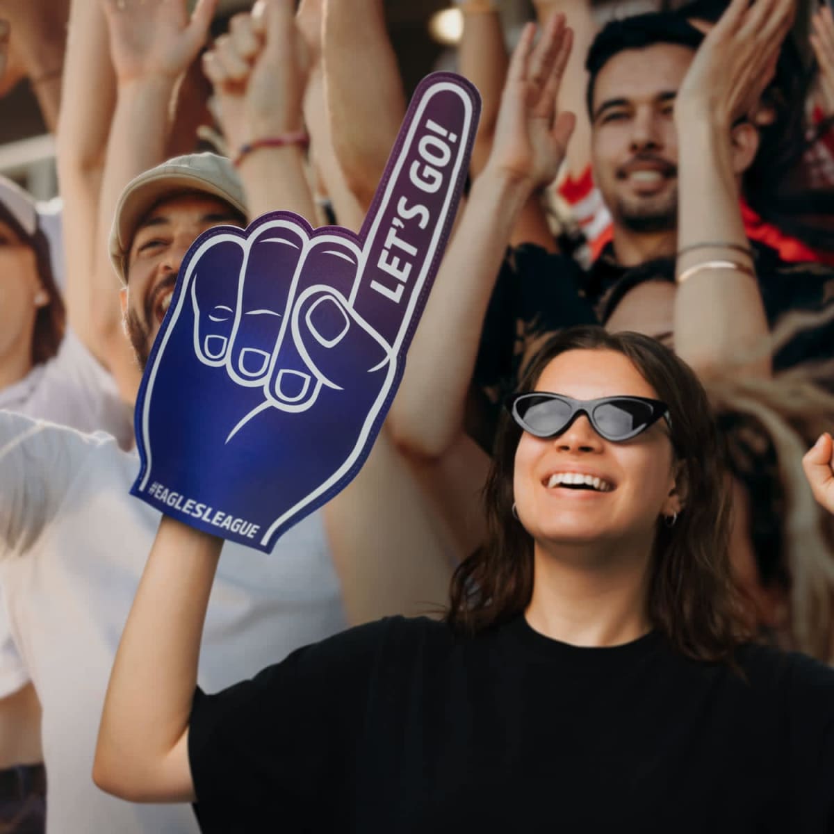 A woman holding a foam finger.