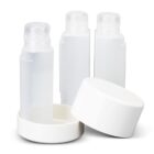Three clear plastic bottles with white caps, one cap removed and lying in front.