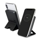 Two smartphones on black wireless charging stands, one showing a 63% charge on the screen.