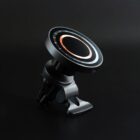 A black magnetic car phone mount with a circular design on a dark background.