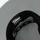 Close-up of the inside brim of a Titleist hat, showing the brand label and stitching.