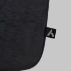 Close-up of a black fabric bag with a small black tag featuring a white geometric logo.