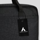 Black fabric bag with a black Archer brand tag attached to the handle.
