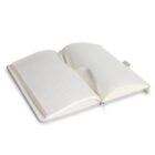 An open lined notebook with a heart-shaped fold in the middle of the pages.