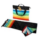 Quilted bag with rainbow stripes that unfolds into a matching striped picnic blanket.
