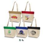 Five canvas tote bags with different colored tops and various logo designs on the front.