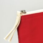 Close-up of a red fabric pouch with a cream zipper and pull tab.