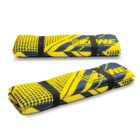 Two folded yellow and blue mats with black straps and graphic patterns.