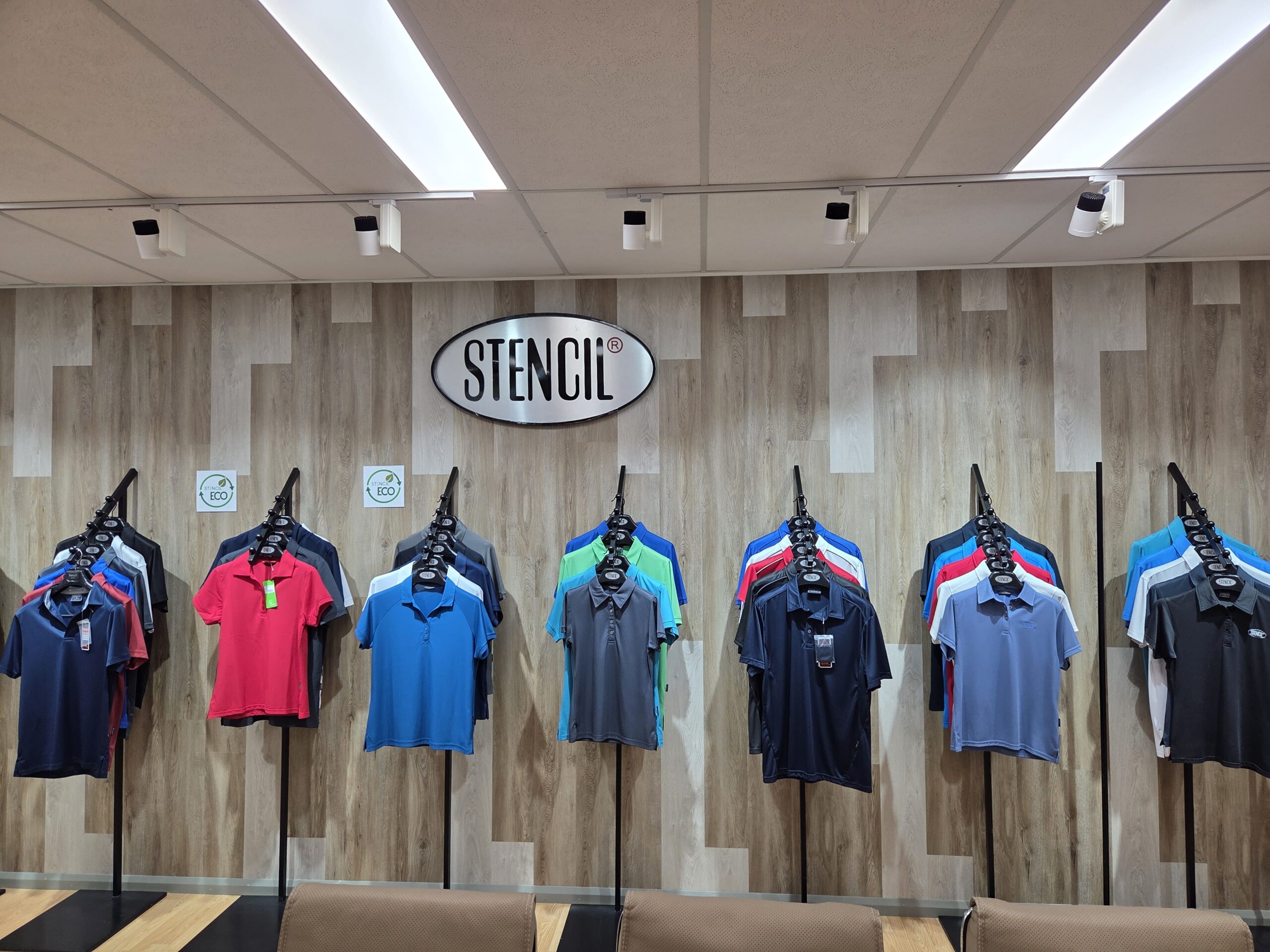 Polo shirts for Aussie organisations hang neatly, with no fabric mistakes, under a STENCIL sign.