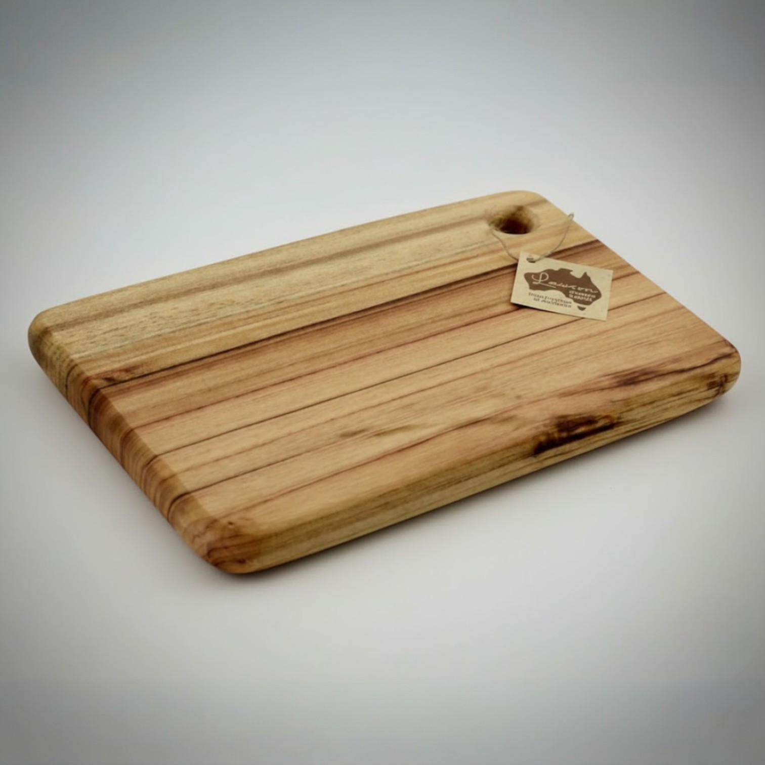 Rectangular wooden cutting board with a tag, perfect as an Australian-made promotional item.