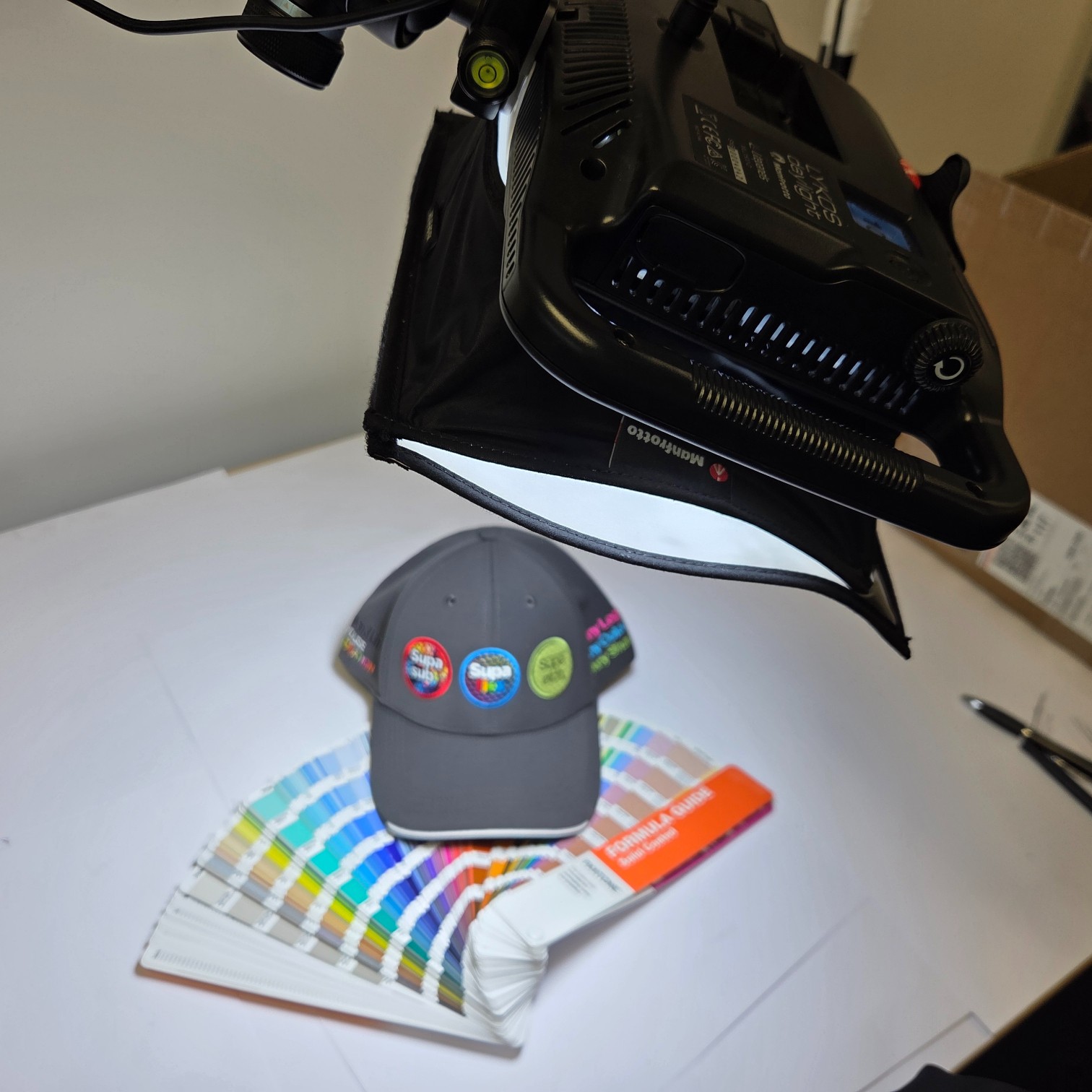 A gray cap on color swatches under studio lighting, ideal for print colour accuracy checks.