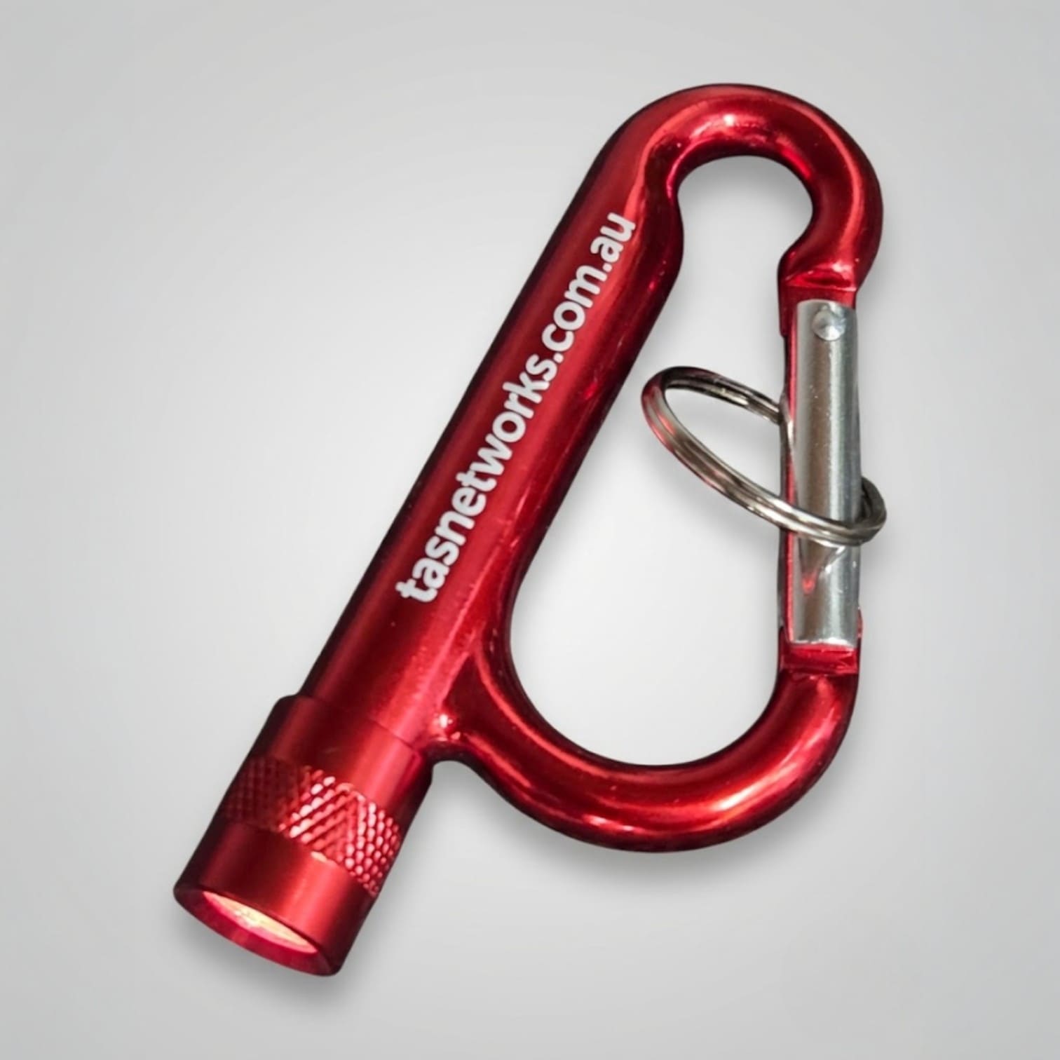 Red carabiner with flashlight and key ring, a unique and effective promotional product Australia.