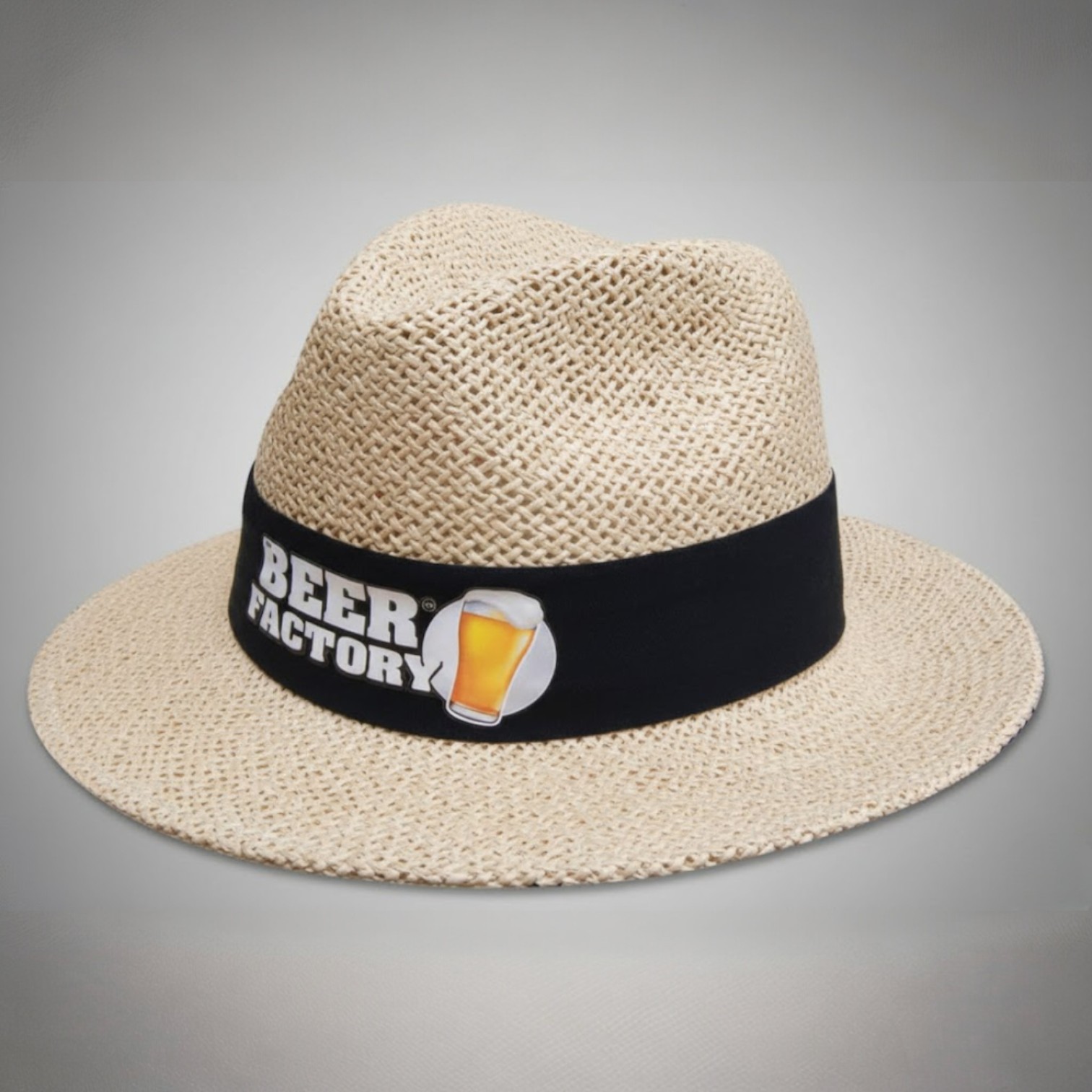A straw hat with a black band labeled BEER FACTORY—one of our unusual promo products.