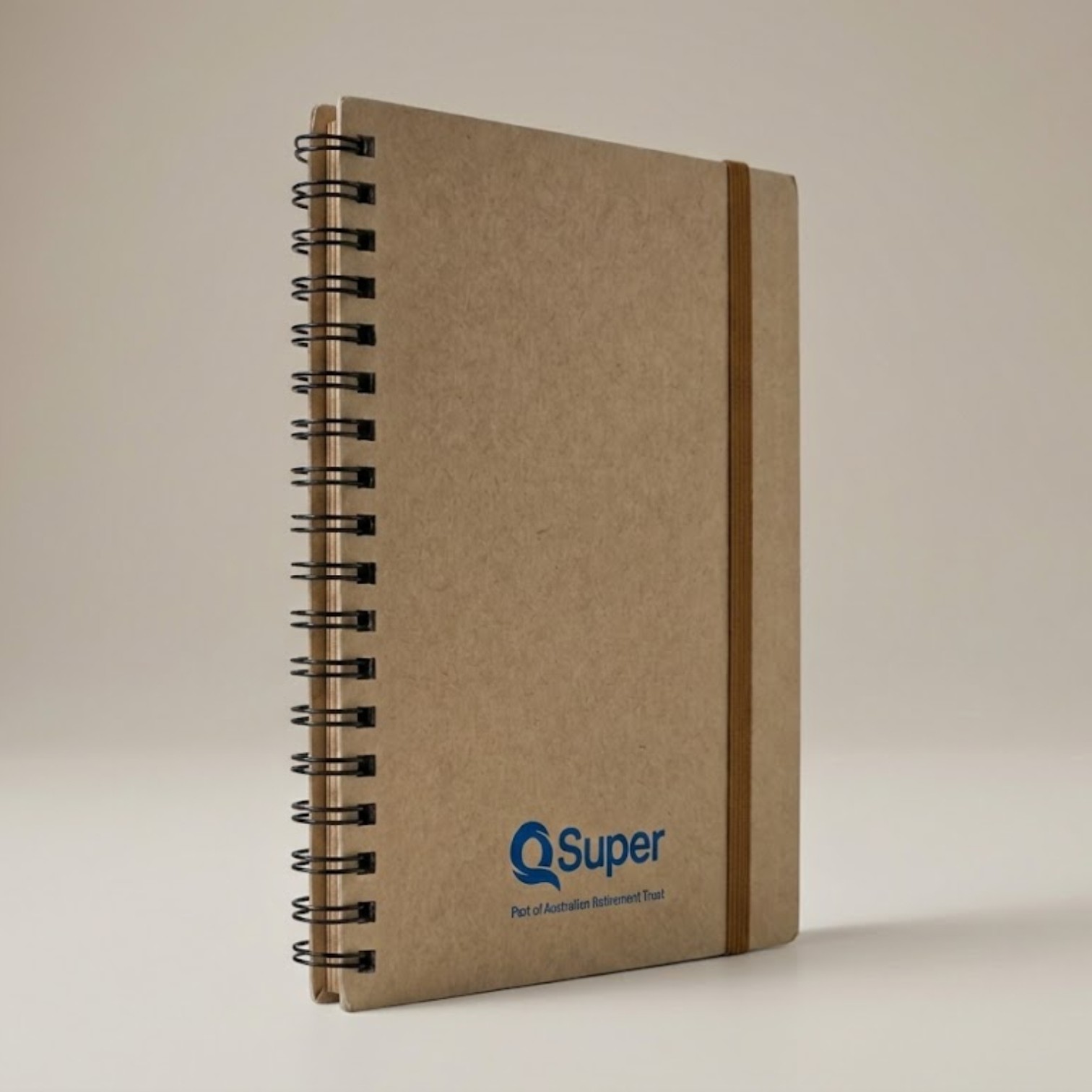 Brown spiral notebook with QSuper logo, elastic band, and included sticky notes.