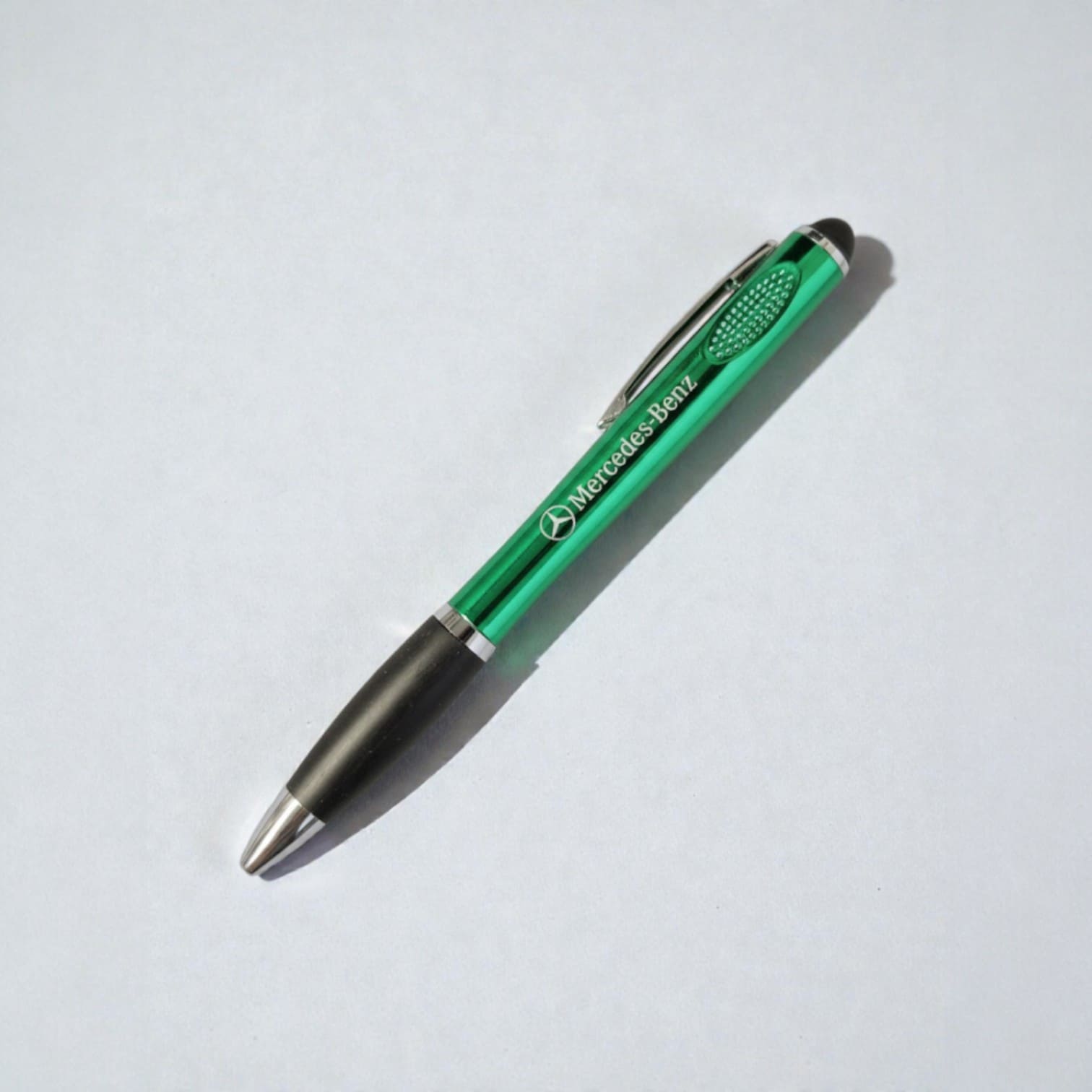 Green Mercedes-Benz pen, ideal promotional product for accounting firms, on white background.