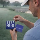 Man holding Golfing Gift Tee Wallet on the course—makes a unique gift for golf lovers.