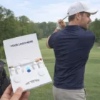 Hand holding Corporate Golf Wedge Tee, perfect for corporate golf events.