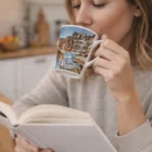 Woman reads a book, sipping coffee from a Kaffee Coffee Mug in her cozy kitchen.