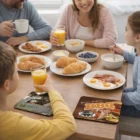 Family enjoys breakfast with croissants and eggs, drinks set on Flexible Coasters.