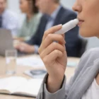 A person applies Zinc Lip Balms during an office meeting.