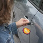 Person unlocking a car with a key featuring colorful Pvc Key Rings on the keychain.