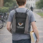 Person with a Zepit Drawstring Backpack holds books and a notebook outdoors.