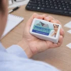 Person holding Business Card Stress Toys beside a Primestone Properties business card.