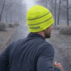 Man jogging on a foggy path, wearing a Hi-Vis Beanie Cap.