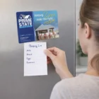 A woman holds a shopping list on the fridge with a Rectangle Fridge Magnet 14 X 10cm above it.
