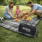 Family enjoying food and games on Summer Picnic Rugs with a basket and soccer ball.
