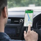 Driver uses a navigation app on a smartphone held by Personalised Harvey Magnetic Phone Holders.